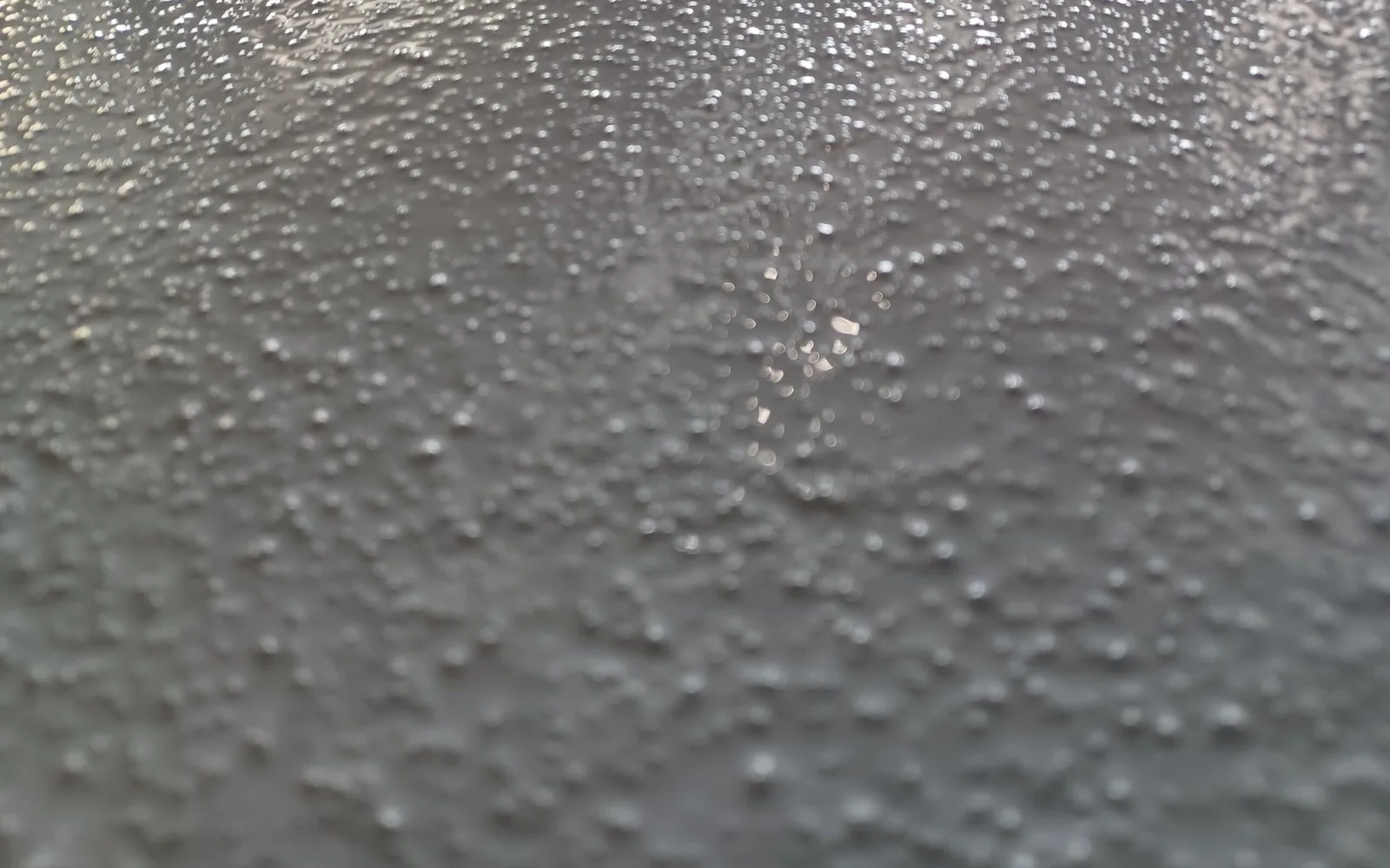 Gray textured floor coating with a light anti-slip texture