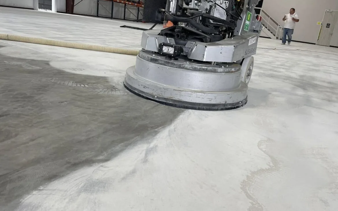 Diamond grinder preparing a concrete slab before a floor coating