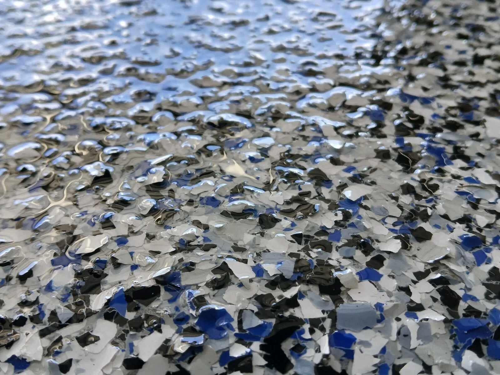 Close-up of blue, black and white epoxy flake in a clear high-gloss topcoat