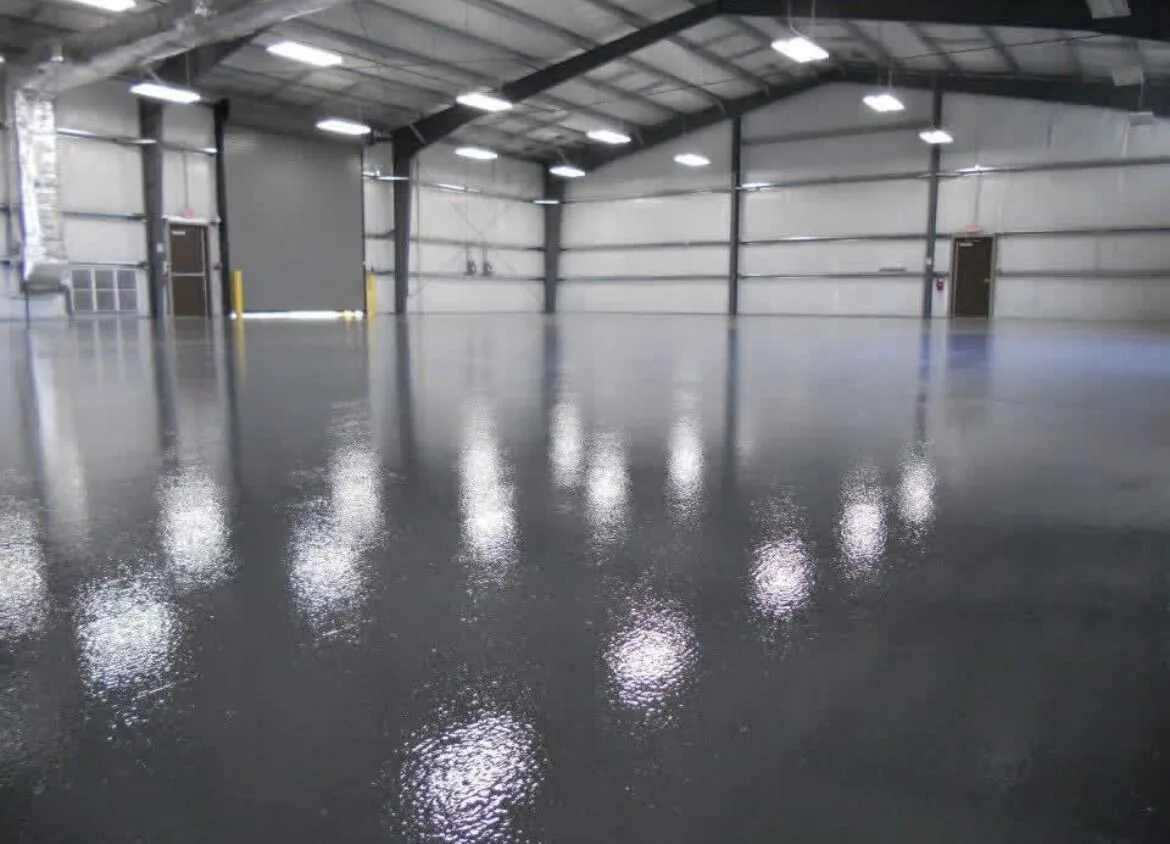 Wide warehouse floor coating reflecting the overhead lights