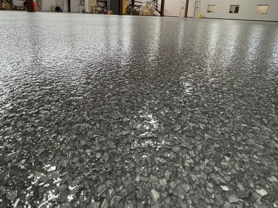 Gray flake floor close up in a steel warehouse