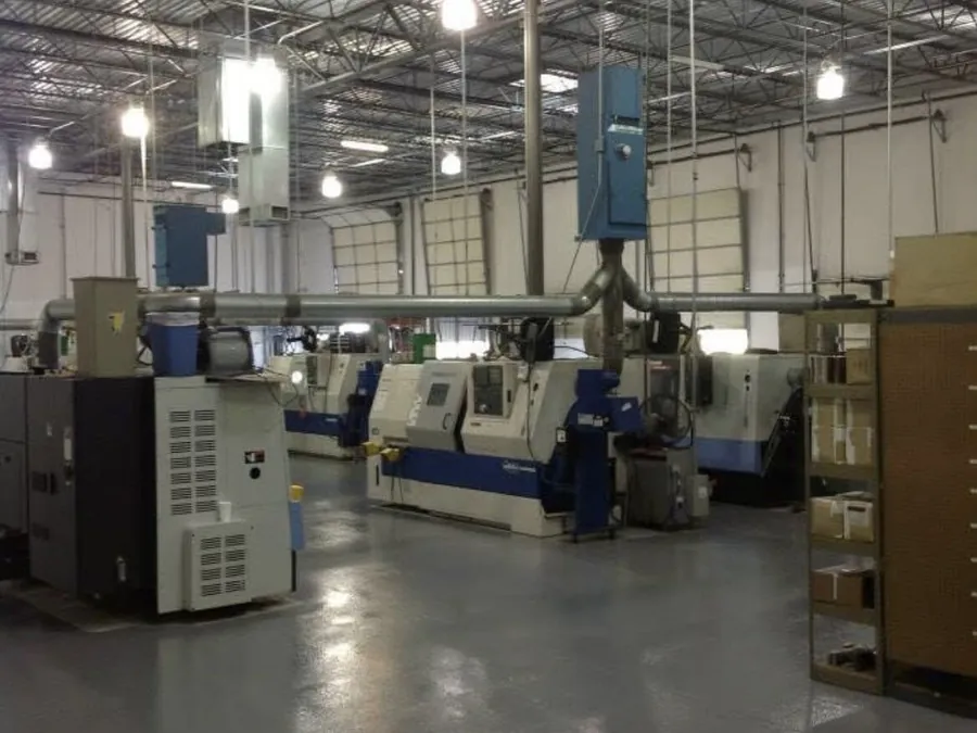 Gray coated floor in a machine shop with CNC equipment
