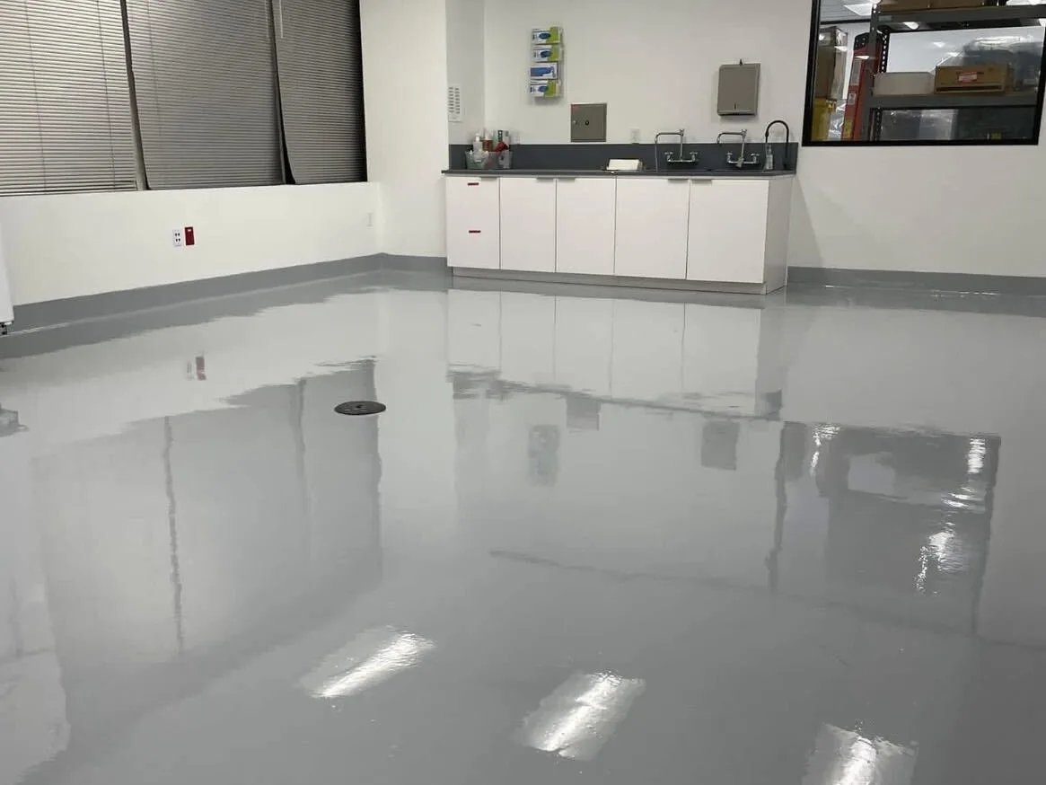 Seamless coated food-prep room floor with a floor drain, sinks and cove base