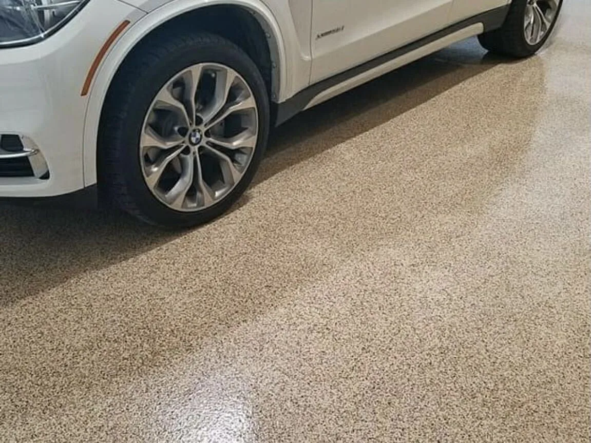 White SUV parked on a tan flake epoxy garage floor