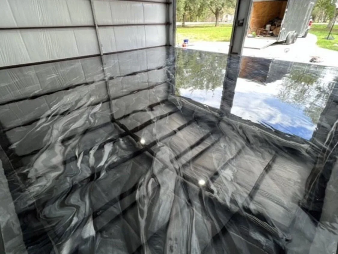 Black and white metallic epoxy floor in a detached shop garage