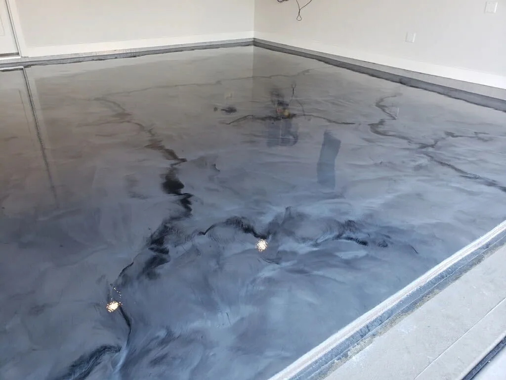 Silver gray metallic epoxy floor in a residential garage