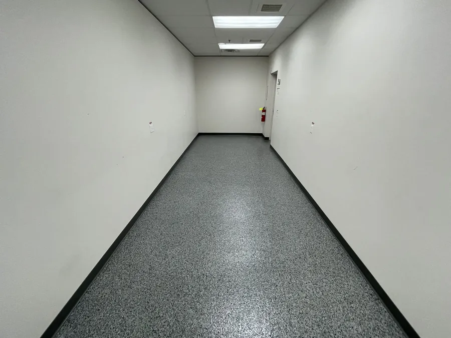Gray flake floor with a black border down a long room