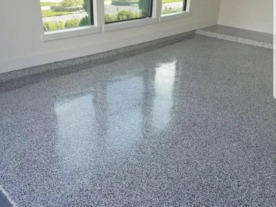 Gray salt and pepper flake floor beside a row of windows