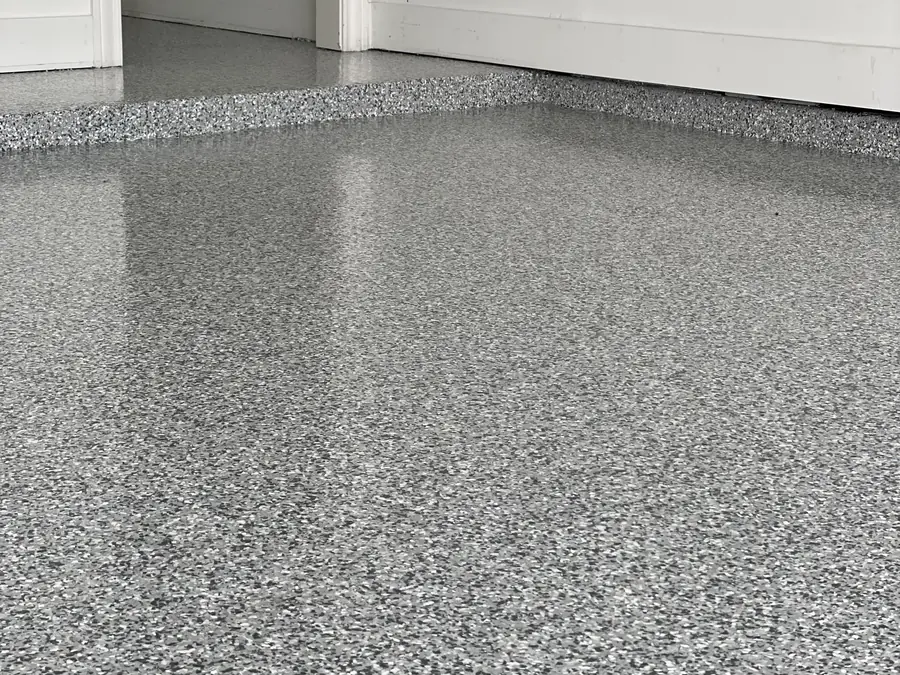 Gray and white flake floor at a doorway with white walls