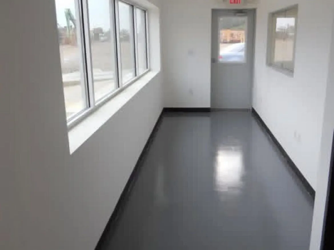 Seamless gray coated corridor floor with cove base in a clean facility
