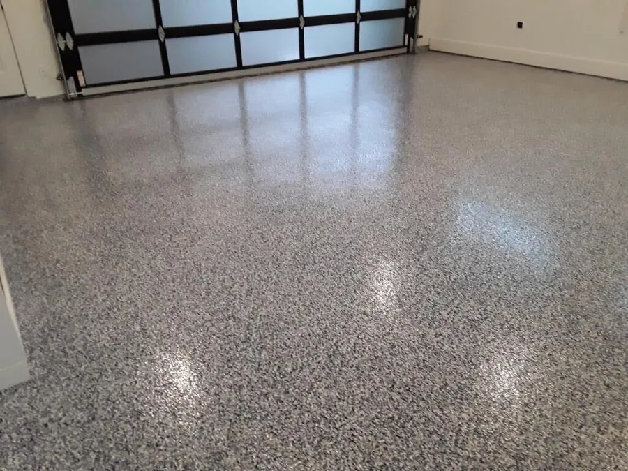 Gray and black full flake garage floor with a glass garage door