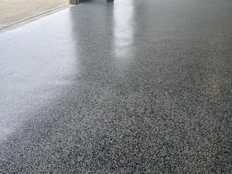 Gray flake garage floor looking out the open garage door