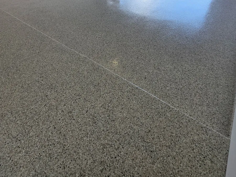 Light gray flake garage floor with the door open to the driveway