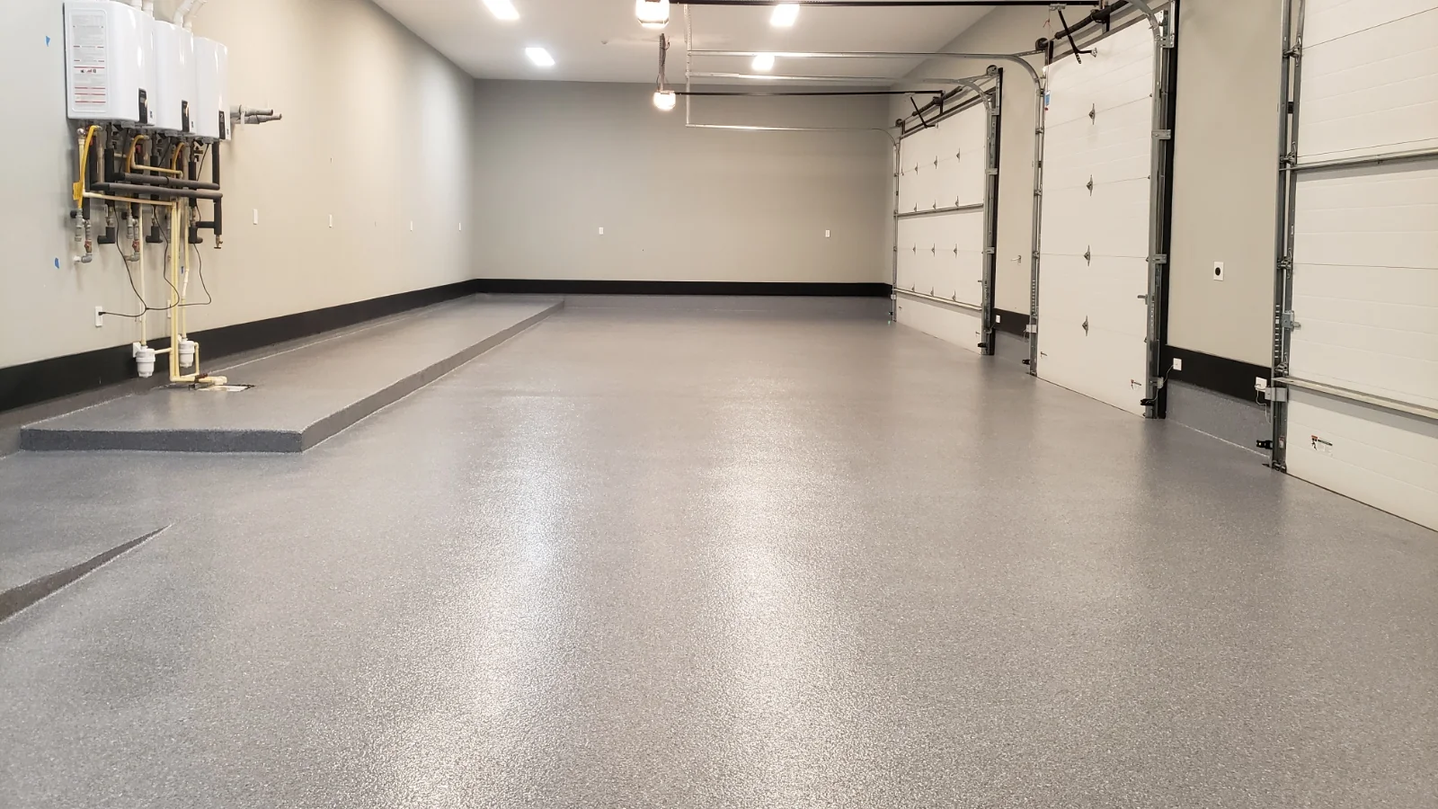 Light gray flake epoxy floor in a three-door garage