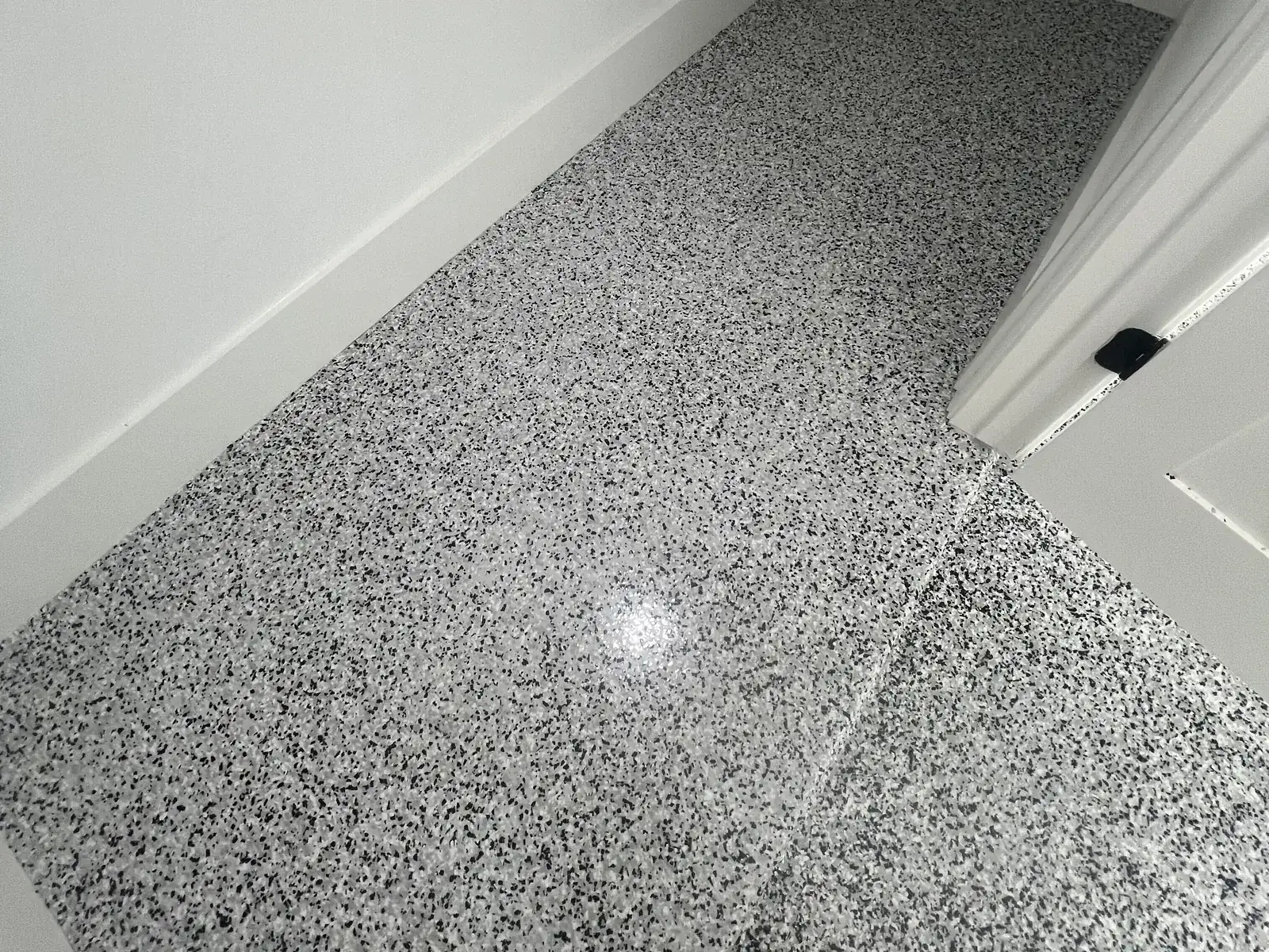 Gray and black flake epoxy floor in a freshly painted room