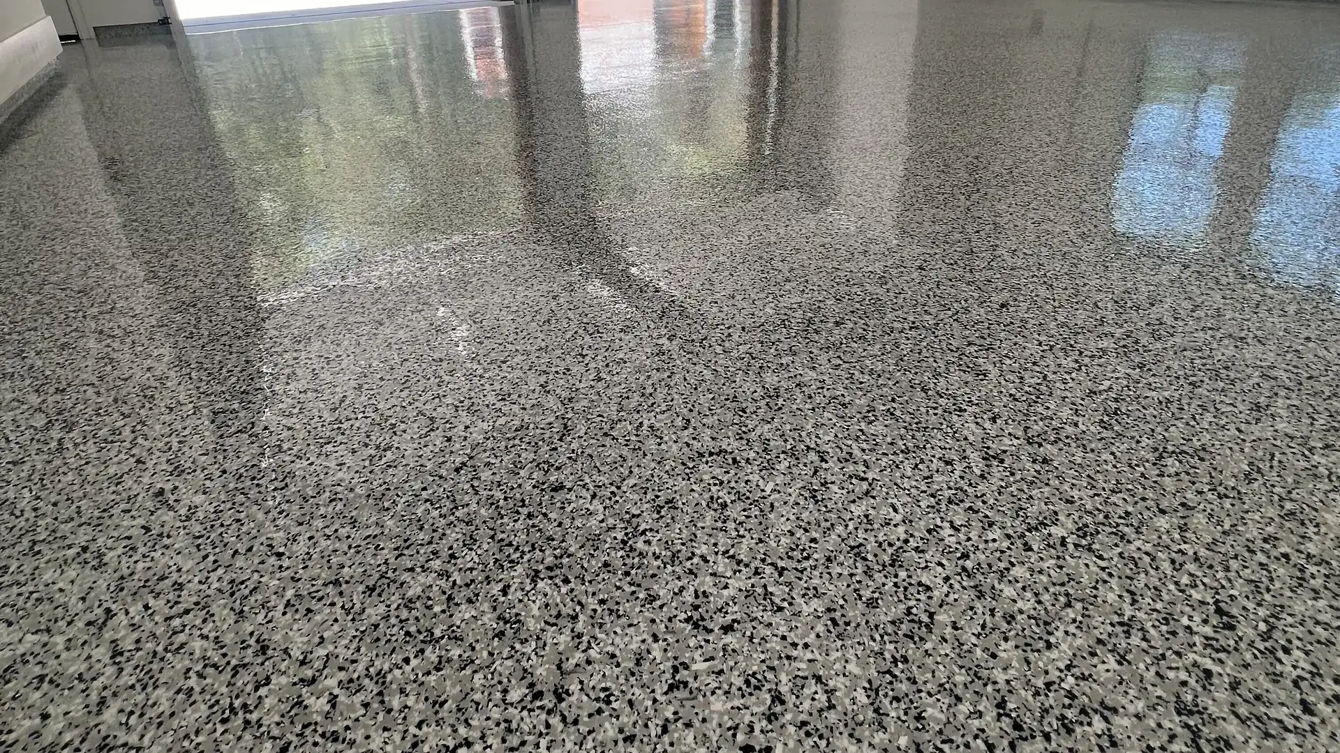Black, white and gray flake epoxy garage floor under a clear high-gloss topcoat