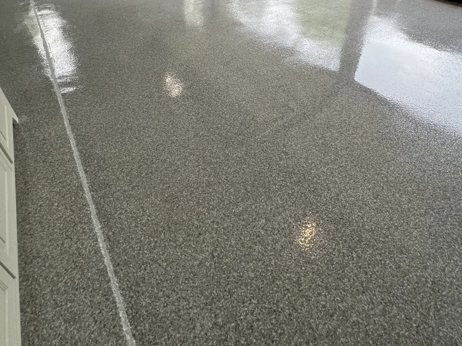 Gray flake epoxy garage floor with a high-gloss topcoat