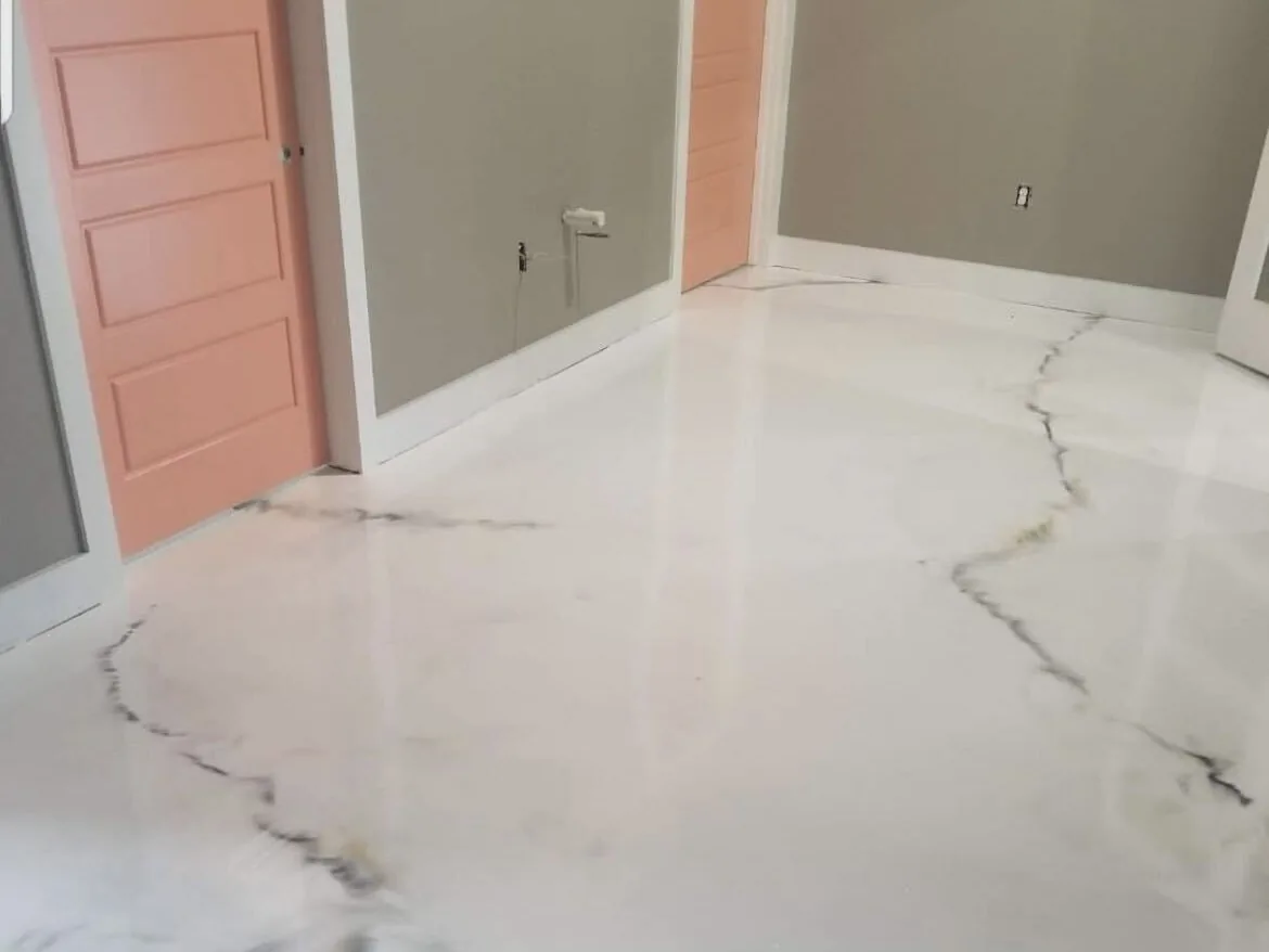 White marble-look metallic epoxy floor with gray veining in a home with coral doors