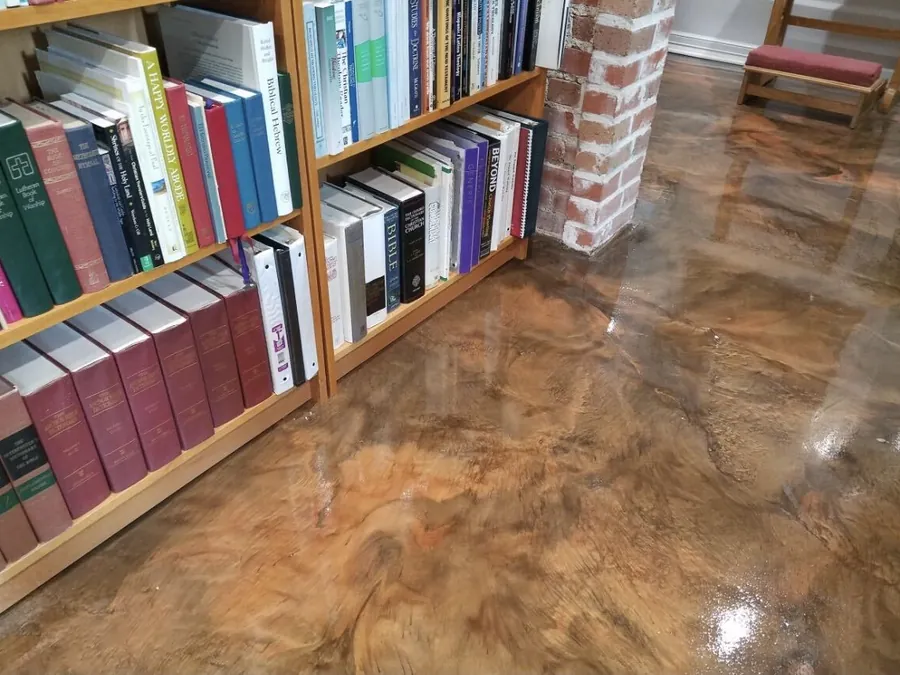 Copper metallic epoxy floor beside a bookcase in a home library