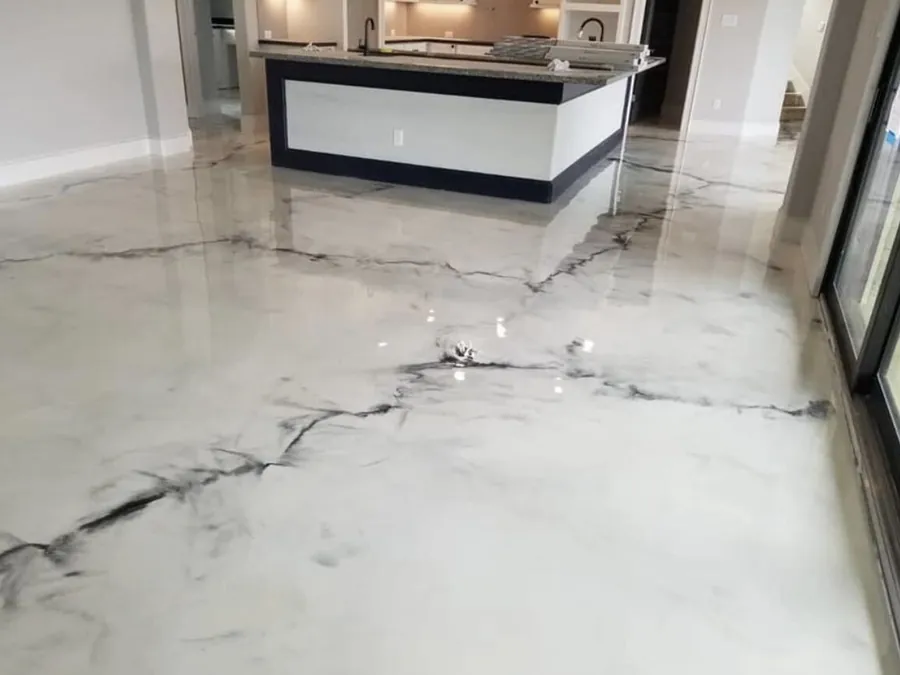 White marble look epoxy floor in an open kitchen and living area