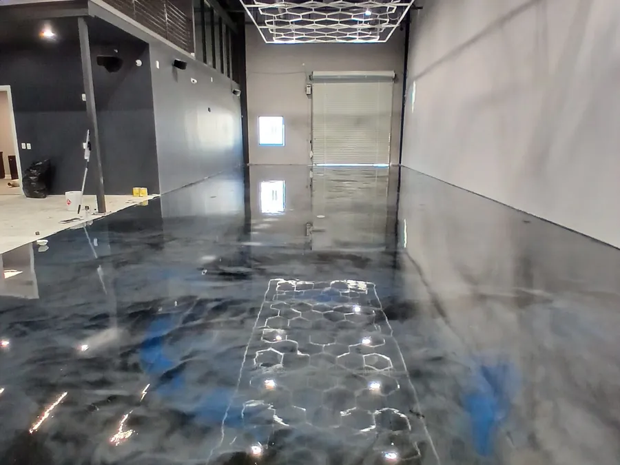 Charcoal and silver metallic epoxy garage floor under a hexagon LED ceiling light