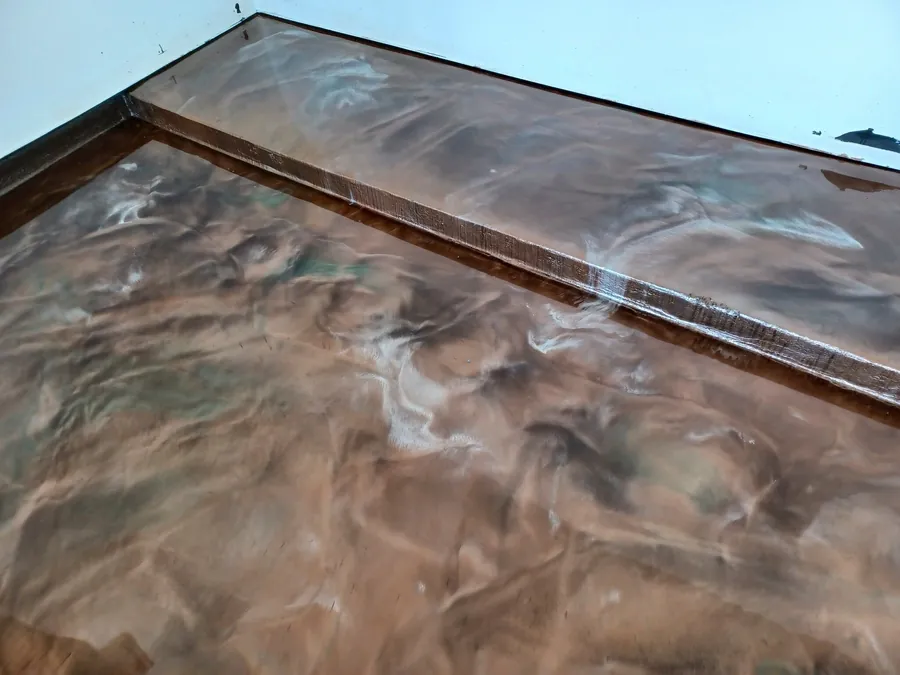 Copper and brown metallic epoxy floor with a step