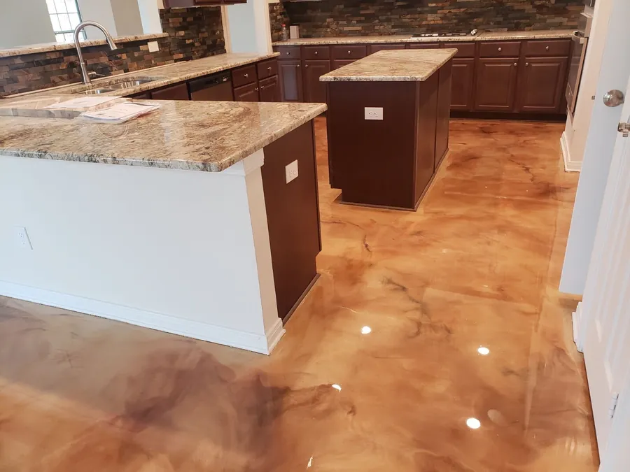 Copper metallic epoxy floor in a kitchen with granite counters