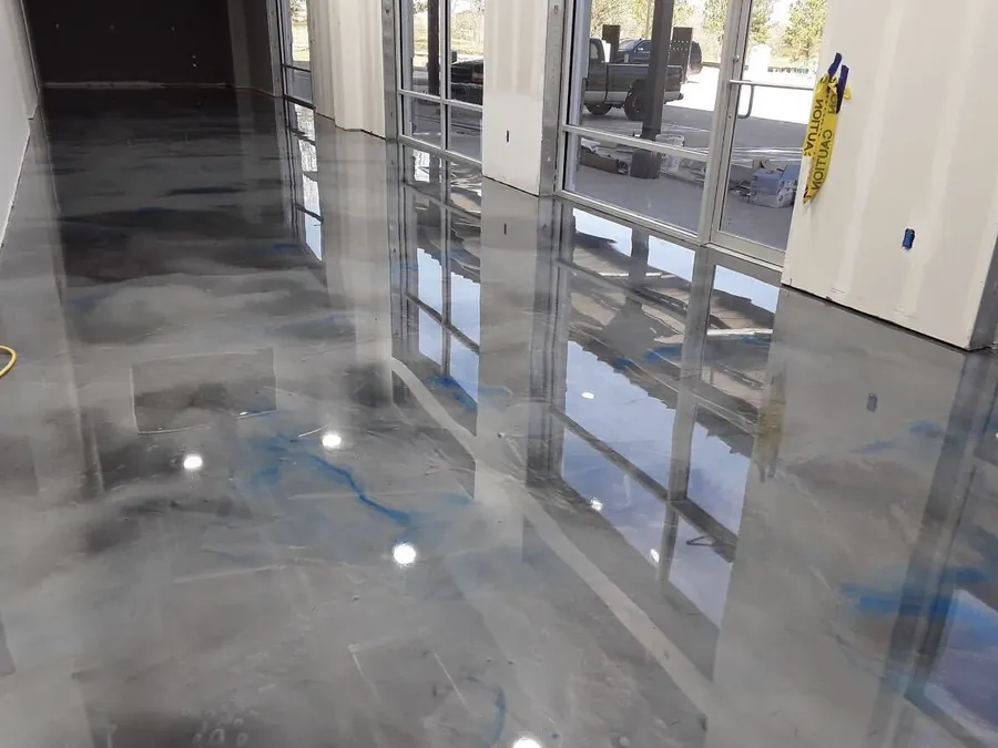 Silver metallic epoxy floor in a showroom with floor to ceiling windows