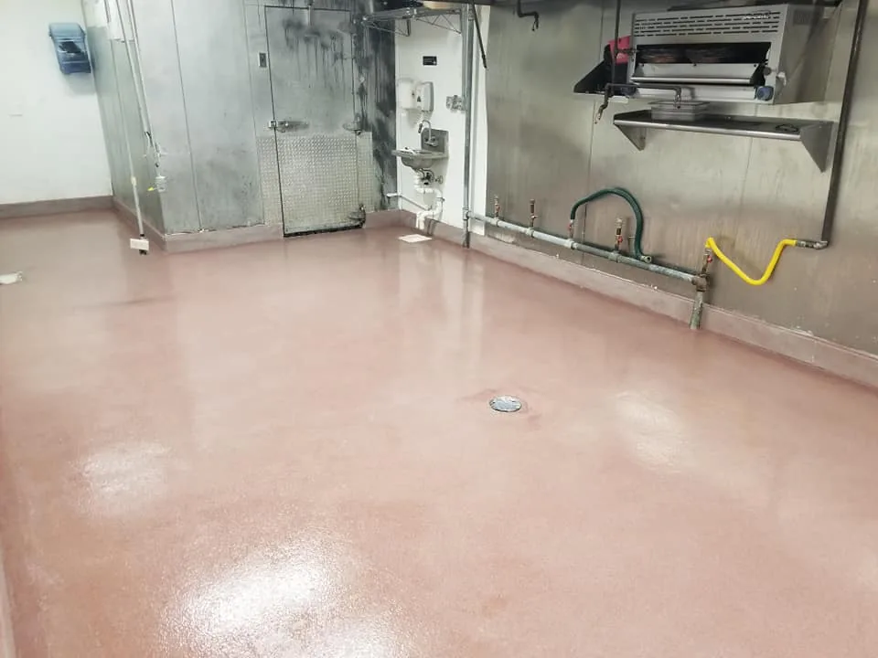 Port Wine quartz floor coating in a commercial kitchen with a floor drain