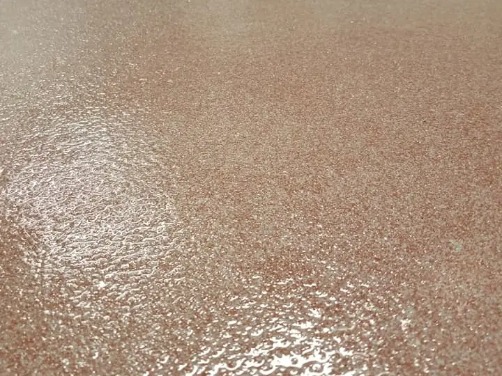 Close-up of a rose quartz broadcast floor with a textured clear coat