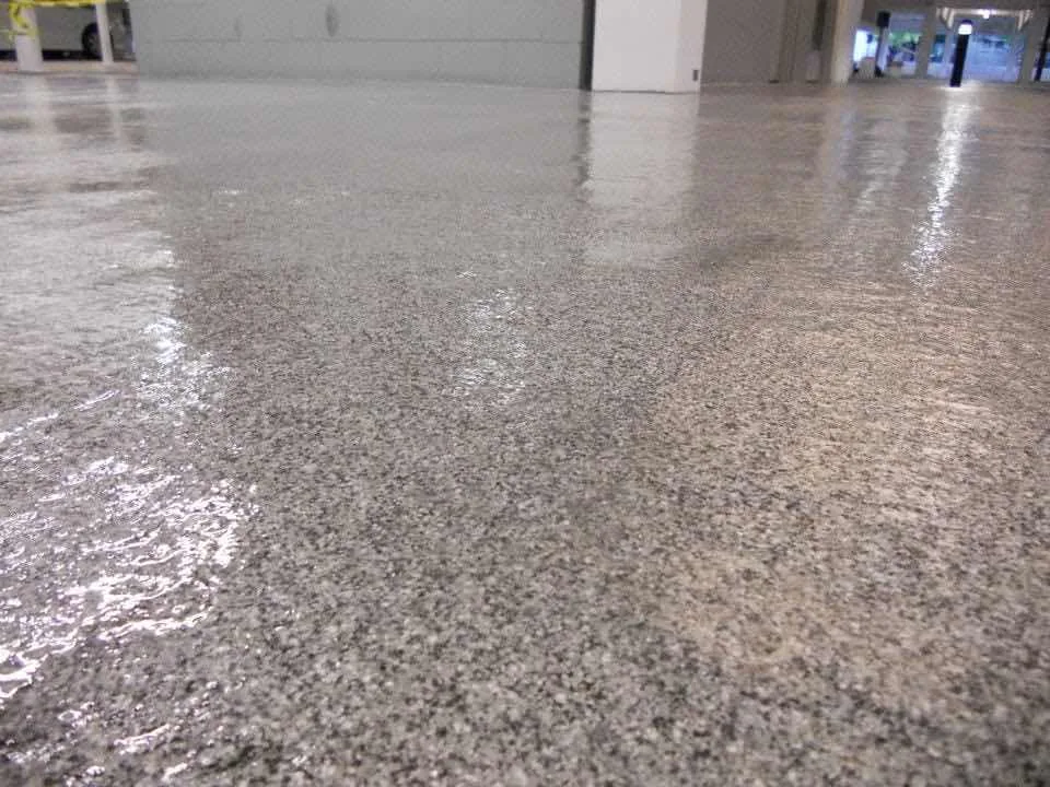 Salt and pepper quartz floor coating in a commercial parking garage