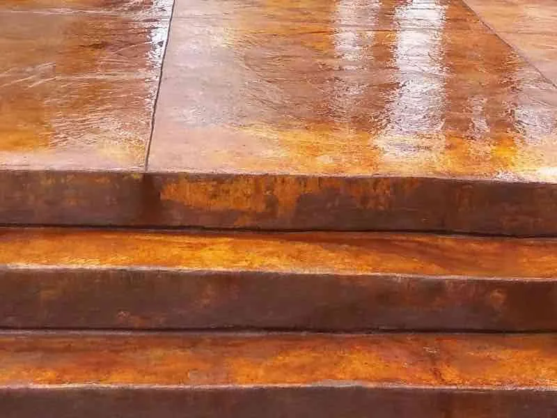 Copper stained concrete patio and steps finished with a glossy sealer