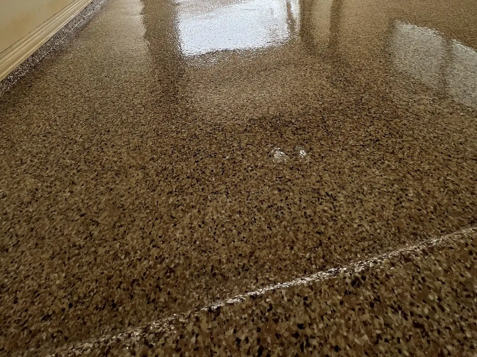 Tan and brown flake epoxy garage floor with the door open