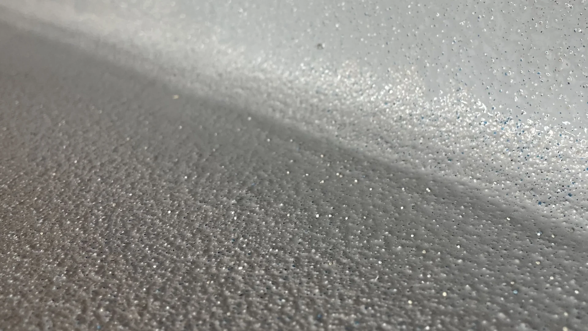 Close view of a gray textured anti-slip floor coating