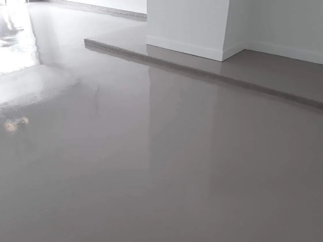 White solid color epoxy floor with a glossy finish inside a Houston home