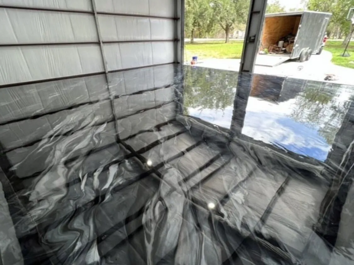 Black and white metallic epoxy floor in a detached shop garage
