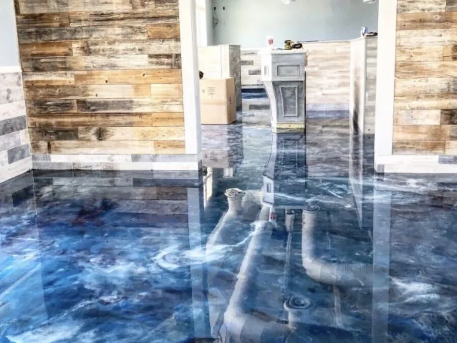 Blue and white metallic epoxy floor beside reclaimed-wood walls