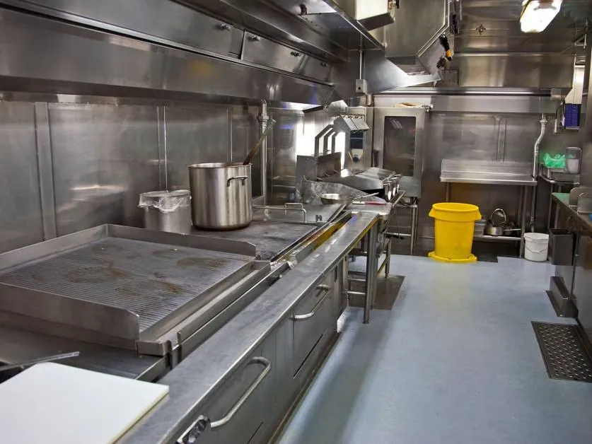 Gray seamless floor coating under a commercial kitchen line