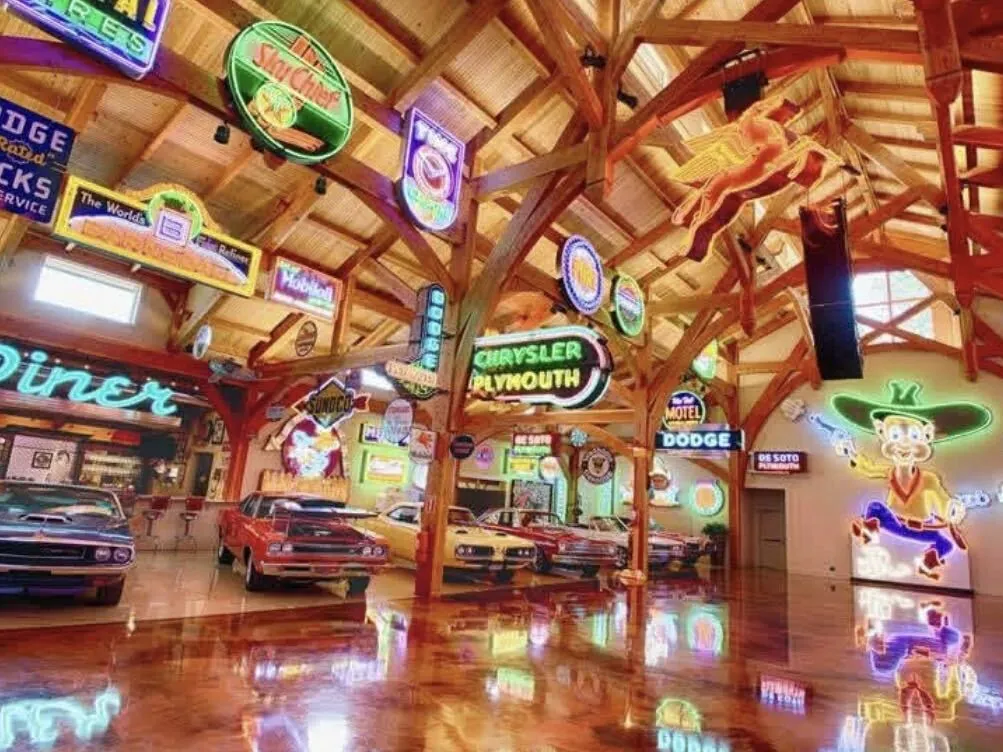 Metallic epoxy floor reflecting the neon signs and vintage cars at Hemi Hideout