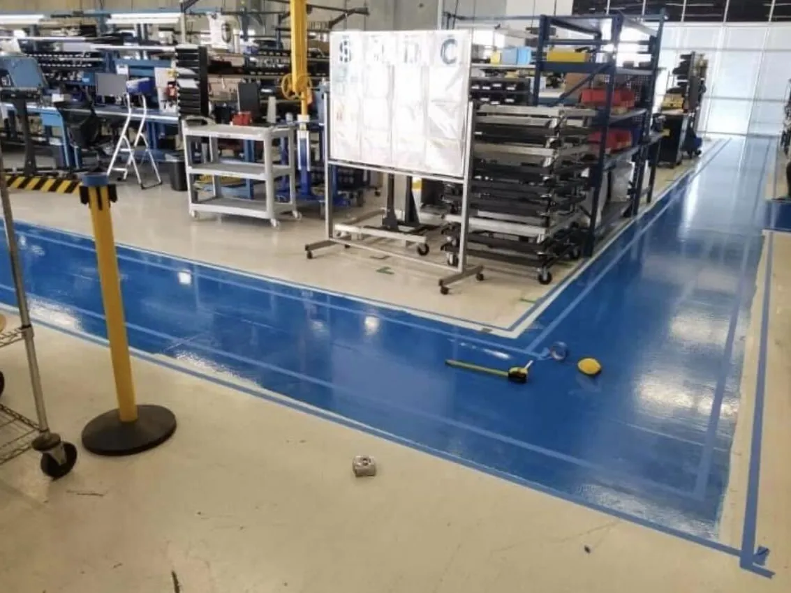 Manufacturing floor with blue walkways and yellow safety striping
