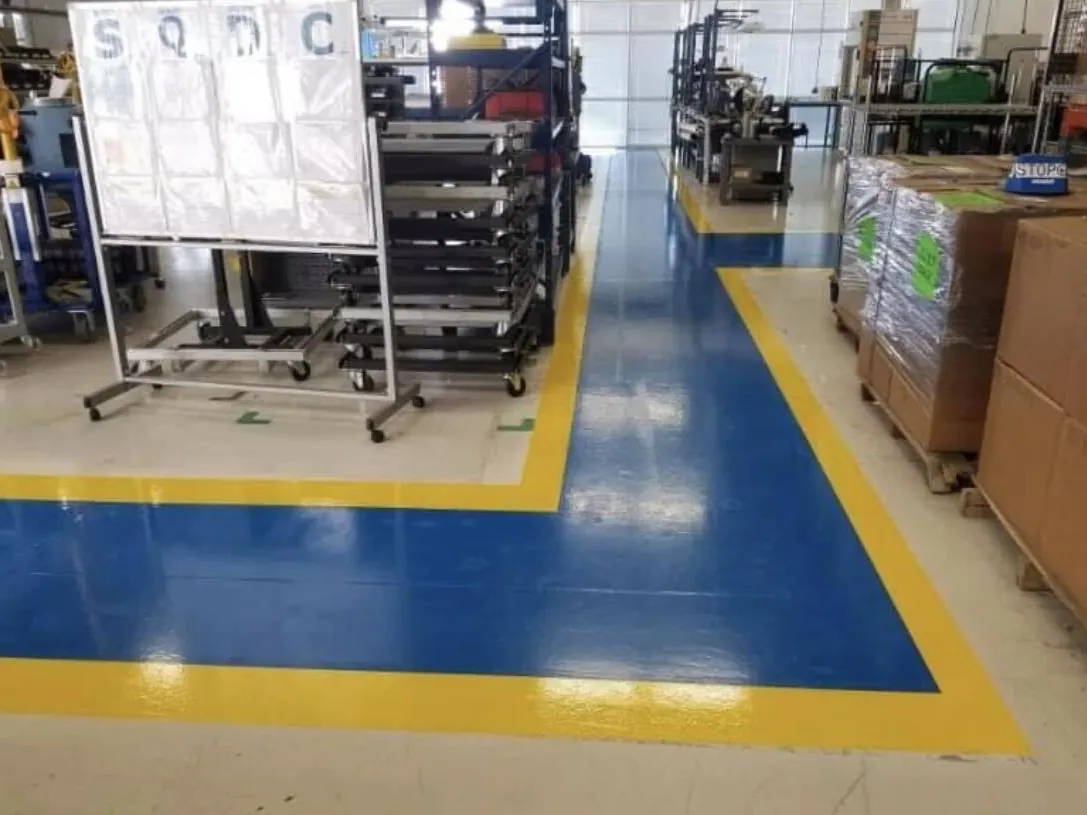 Blue and yellow safety lines on a coated manufacturing floor