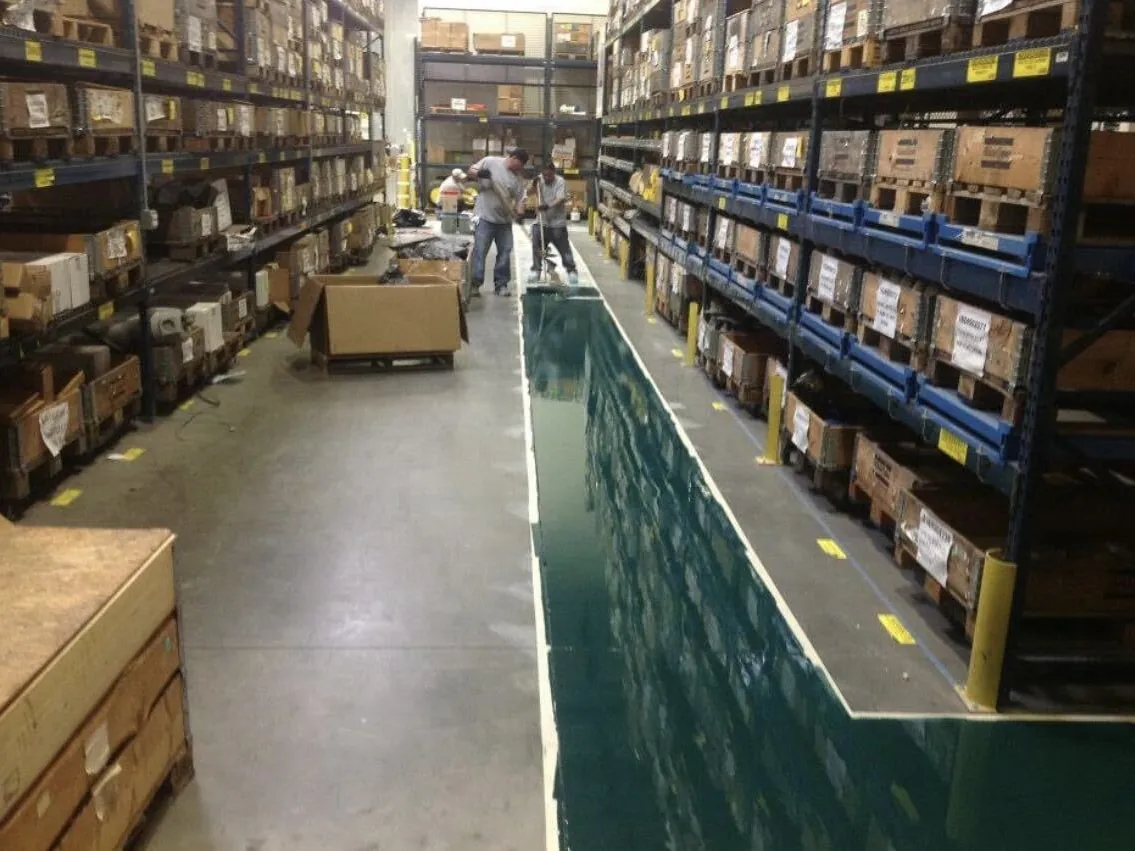Green coated aisle between pallet racking in a warehouse