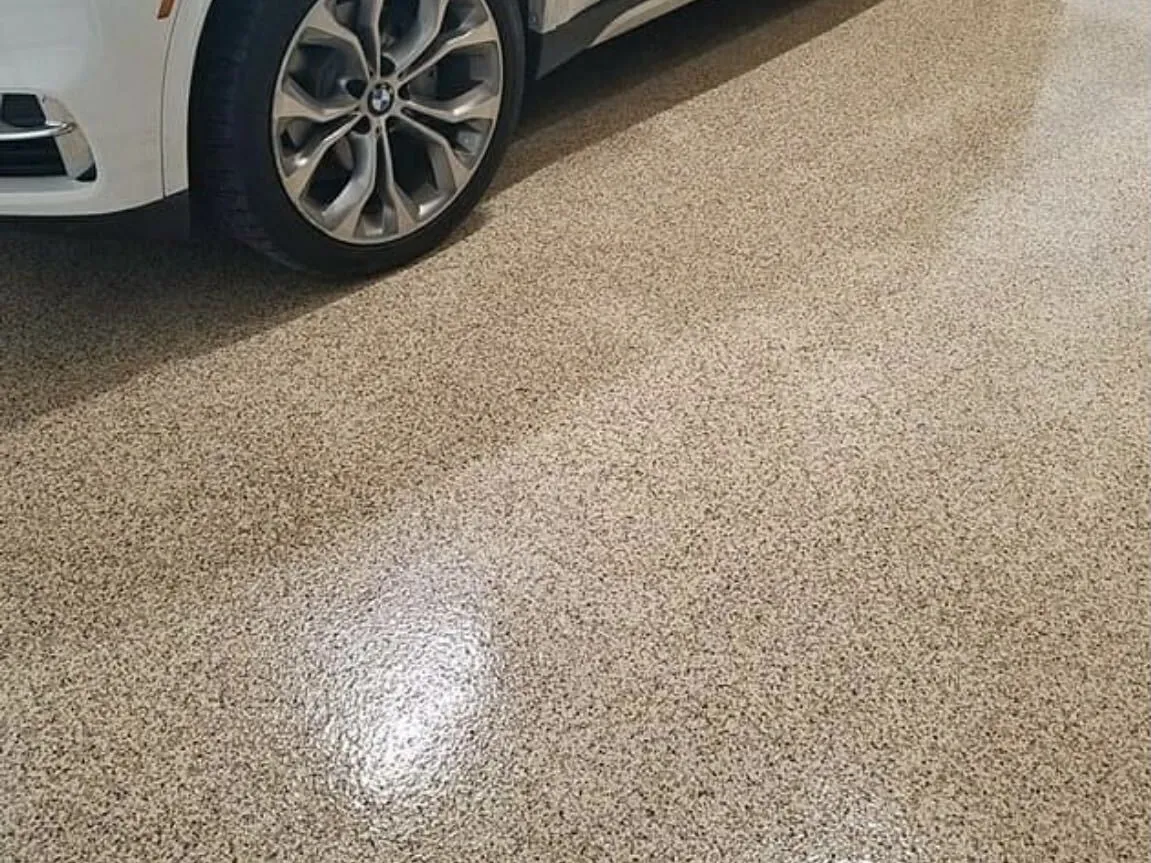 White SUV parked on a tan flake epoxy garage floor