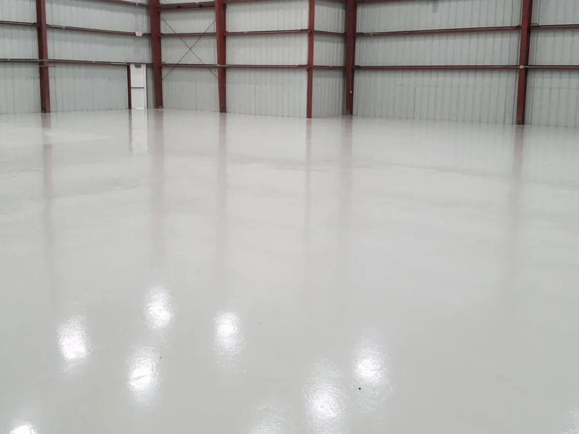 High-gloss white floor in a steel hangar building